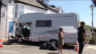 Damaged motorhome and police cordon