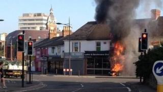 Car on fire inside the entrance of a club in Swindon