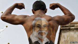 A supporter shows his back, with an image of Gujarat Chief Minister Narendra Modi, in Ahmedabad in this July 3, 2011 file photo