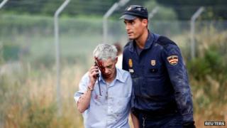 Train driver Francisco Jose Garzon Amo is helped by a policeman after a train crashed near Santiago de Compostela, 24 July 2013.