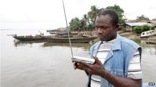 A Bakassi resident listening to the radio in 2008, Cameroon
