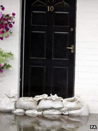 Sandbags against a front door as a flood defence