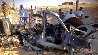 Egyptians gather near a wreckage of a car in El-Arish. Photo: July 2013