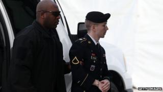 US Army Private First Class Bradley Manning is escorted by military police as he arrives for his sentencing at military court facility for the sentencing phase of his trial in Fort Meade, Maryland on 21 August 2013