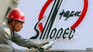 A Chinese worker installs Sinopec logo