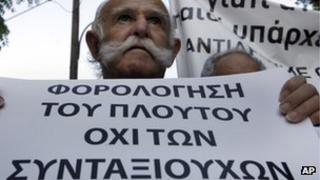 Cypriot protester holding banner