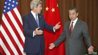 U.S. Secretary of State John Kerry gestures next to China's Foreign Minister Wang Yi (R) at the Chinese Ministry of Foreign Affairs in Beijing April 13