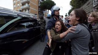 Anti-fascist demonstrators shout as the hearse carrying the coffin of Nazi war criminal Erich Priebke arrives in Albano Laziale near Rome