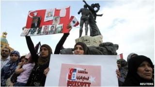 Relatives of the nine Lebanese held as hostages by rebels in the northern Syria town of Azaz hold placards during a sit-in to demand their release
