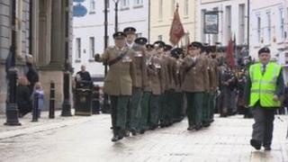 The regimental banner is paraded through Enniskillen