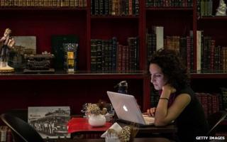 Woman uses laptop in Rio de Janeiro