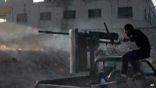 A Syrian rebel fires a weapon in Aleppo. File photo