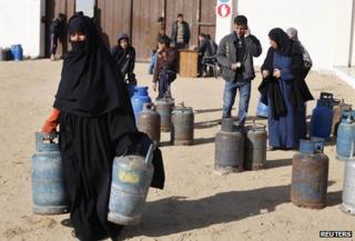 Palestinians collecting gas canisters in Rafah, Gaza - file pic