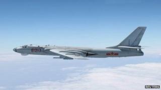 A Chinese military plane H-6 bomber flies through airspace between Okinawa prefecture's main island and the smaller Miyako island in southern Japan, out over the Pacific, in handout photo taken 27 October 2013 by Japan Air Self-Defence Force and released by the Joint Staff Office of the defence ministry of Japan
