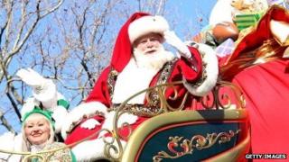 Santa waves from his float during the 2013 Macy's Thanksgiving Day Parade in New York City.