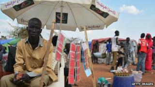 A man sells phone cards at a displaced persons' camp in Juba
