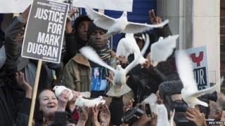 Family members of Mark Duggan, including his mother Pamela (left), release doves during a vigil for him outside Tottenham Police Station