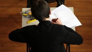 Boy writing in an exam