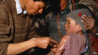 Child being given a measles vaccine in India