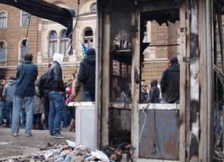 People stand around the damaged presidency building in Sarajevo, 9 February