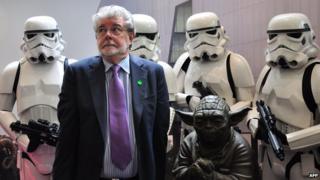 George Lucas with Stormtroopers and a statue of Yoda at the opening of ILM's facility in Singapore