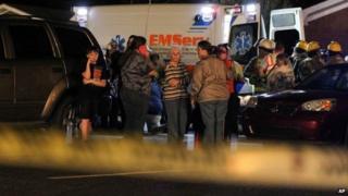 Members of Freedom Baptist Church gather outside the Family Life Center following a second floor collapse that injured up to 35 youths during Wednesday night services 19 February 2014