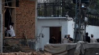 Pakistani security personnel gather outside the Iranian consulate following a suicide bomb attack in Peshawar on February on February 24, 2014.
