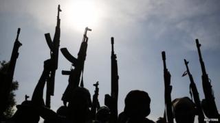 Rebel fighters hold up their weapons as in Upper Nile state, South Sudan (11 February 2014)