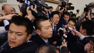 Xinjiang Communist Party Secretary Zhang Chunxian jostled by journalists in Beijing on 6 March 2014