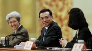Chinese Premier Li Keqiang (C) attend a news conference after the closing session of the National People's Congress (NPC) at the Great Hall of the People on 13 March 2014 in Beijing, China