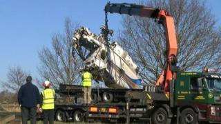 Air accident investigators remove helicopter