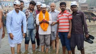 The head of the Aam Aadmi (Common Man) Party Arvind Kejriwal (C) poses for a photograph as he visits the river Ganges in Varanasi on March 25, 2014. T