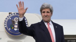 US Secretary of State waves as he boards an Air Force jet on 2 April, 2014.