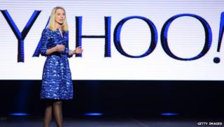 Marissa Mayer in front of yahoo logo