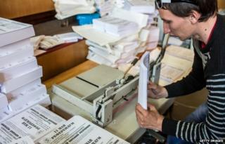 A man prepares ballots and flyers for a planned referendum seeking greater autonomy from the central government in Kiev, scheduled for May 11, in a building occupied by pro-Russian protesters on May 7, 2014 in Donetsk, Ukraine.