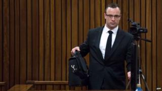 Oscar Pistorius arrives for his trial on charge of murdering his girlfriend Reeva Steenkamp, at the high court in Pretoria (13 May 2014)