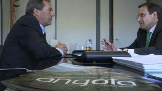 Jose Cruz talks to an adviser about working in Angola