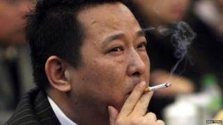 Liu Han, former chairman of Hanlong Mining, smokes a cigarette during a conference in Mianyang, Sichuan province, in this file picture taken 21 March 2008