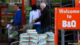 Customers exit a B&Q home improvement store,