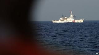 This picture taken on May 13, 2014 from a Vietnamese coast guard ship shows a Chinese coast guard vessel sailing near the area of China's oil drilling rig in disputed waters in the South China Sea.