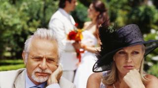 An unhappy couple attends a wedding