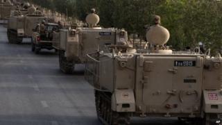 Pakistani army troops ride military vehicles following an operation launched against the Taliban in North Waziristan, in Karachi, Pakistan, 16 June 2014