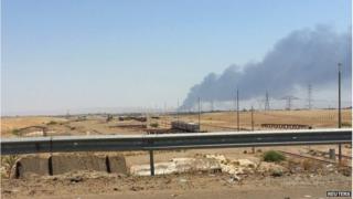smoke rises from a oil refinery in Baiji, north of Baghdad June 19, 2014.