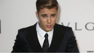 Canadian pop singer Justin Bieber arrives for amfAR"s Cinema Against AIDS 2014 event in Antibes during the 67th Cannes Film Festival 22 May 2014