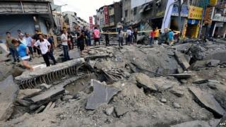 Local residents look at the damage caused by gas explosions in the southern Taiwan city of Kaohsiung on 1 August 2014