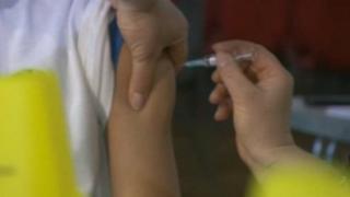 Child being vaccinated with MMR jab