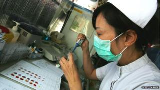 A Chinese medical worker prepares a blood donation at a hospital in Beijing - 7 September 2007