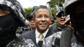 Francisco Flores smiles as he hands himself in to the courts.