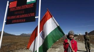 An Indian girl poses for photos with an Indian flag at the Indo China border in Bumla at an altitude of 15,700 feet (4,700 meters) above sea level in Arunachal Pradesh, India.
