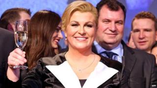 Kolinda Grabar-Kitarovic toasts next to her husband Jakov as she celebrates her win - 11 January 2015